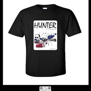 May include: Black t-shirt with a white graphic of a person holding a rifle. The graphic includes the text "HUNTER S. Thompson".