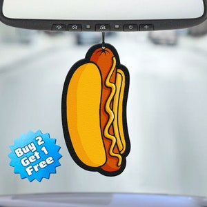 May include: A yellow and brown cartoon hot dog car air freshener with the text "Buy 2 Get 1 Free" on a blue starburst.