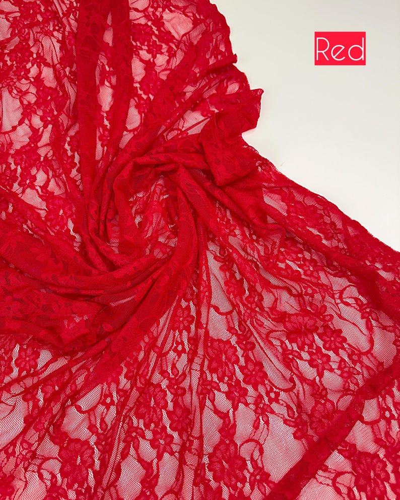 May include: Bright red lace fabric with a floral pattern. The delicate material is draped and folded, creating a textured effect. The word "Red" is in a red box in the upper right corner. Ideal for sewing projects, apparel, and crafts.