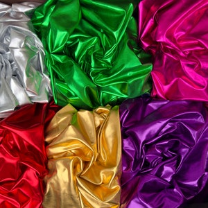 May include: Six different colors of shiny, metallic fabric. The colors are silver, green, pink, red, gold, and purple.