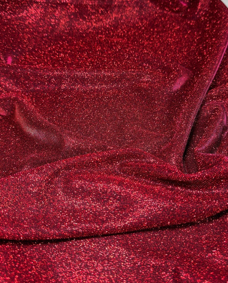 May include: Red sparkly fabric with a textured surface.