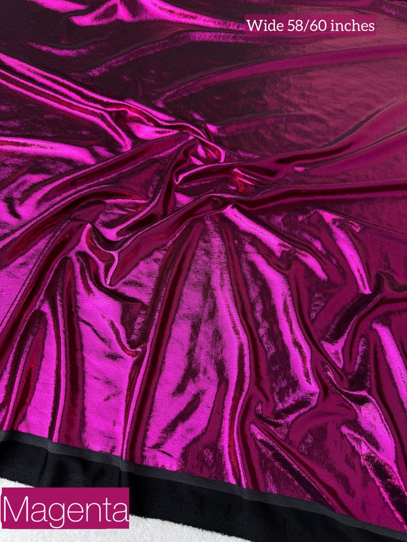 May include: A vibrant magenta fabric with a high-gloss, metallic finish and a crinkled texture. The material is draped in soft folds, creating light and shadow across the surface. Text on the image reads Wide 58/60 inches and Magenta.