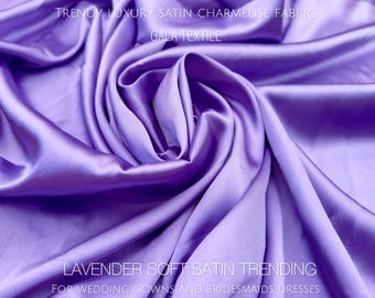 May include: A close-up of a soft, lavender satin fabric. The fabric is draped and folded, showcasing its luxurious texture. The text "TRENDY LUXURY SATIN CHARMEUSE FABRIC" and "GALA TEXTILE" is visible at the top of the image. The text "LAVENDER SOFT SATIN TRENDING" and "FOR WEDDING GOWNS AND BRIDESMAIDS DRESSES" is visible at the bottom of the image.