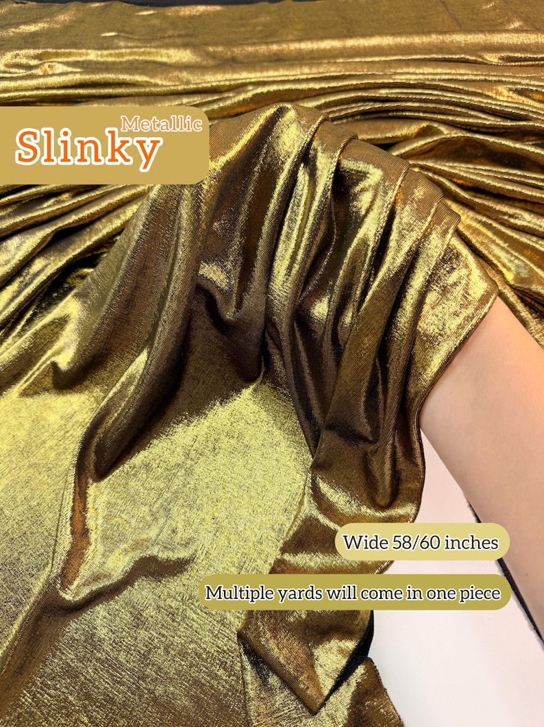 May include: A metallic gold slinky fabric with a shimmering, reflective surface. The textile features a fluid drape and a fine, textured weave. Text on the image reads: Metallic Slinky, Wide 58/60 inches, Multiple yards will come in one piece.