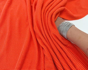 Oranje geribbelde golvende gebreide stof, 4-way stretch gekrulde rib, luxe oranje stof op maat gesneden, voor kleding, doe-het-zelfprojecten en mode
