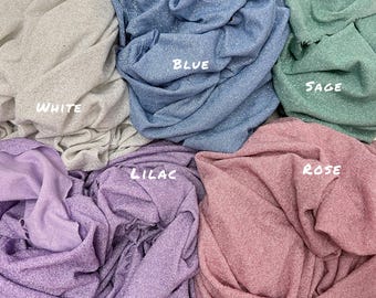 May include: A close-up of six different colors of sparkly fabric swatches. The swatches are labeled "White", "Blue", "Sage", "Lilac", "Rose", and "Sage".
