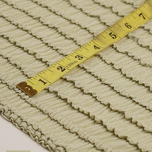 Sage green ruffle knit stretch fabric. Soft pre-smocked poly spandex yardage for bralettes, intimates, and boutique clothing.