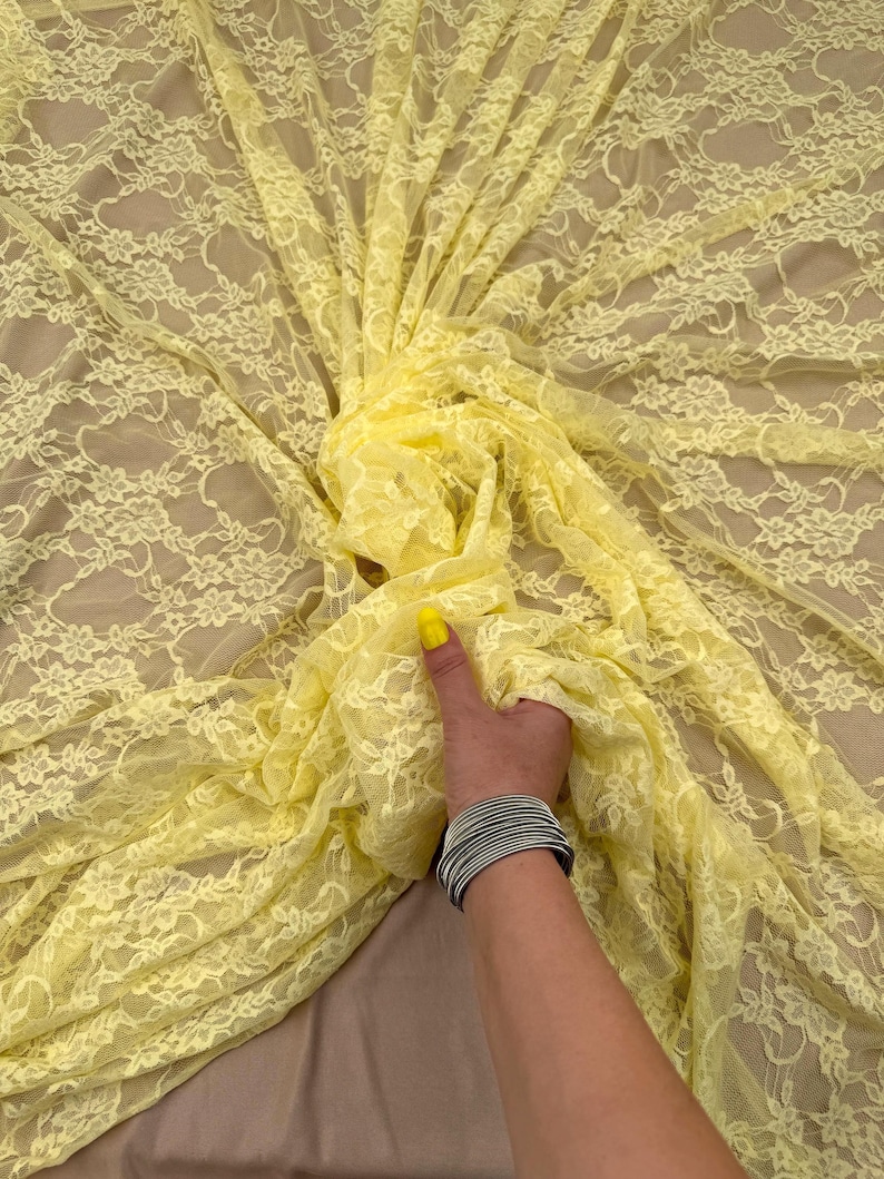 Mustard Yellow Stretch Floral Lace Fabric Draped To Show A Backless Evening Gown Style, Elegant Sheer 80 Gsm Material For Spring Fashion And Apparel.