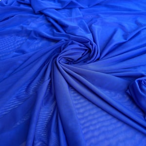 May include: A close-up of a bright blue sheer fabric with a soft, flowing texture. The fabric is draped and folded, creating a sense of movement and lightness.