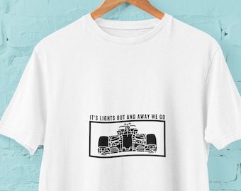 May include: White t-shirt with a black graphic of a race car and the text "It's lights out and away we go."