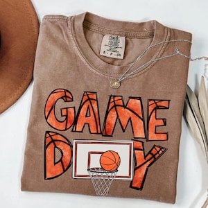cute basketball shirt featuring a game day graphic made with basketball doodle font for a one of a kind piece