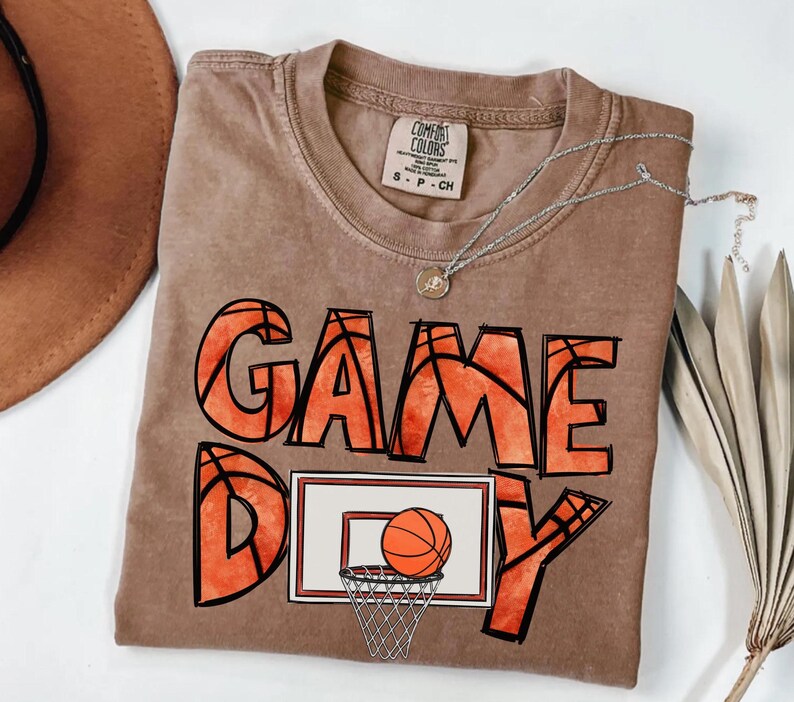 cute basketball shirt featuring a game day graphic made with basketball doodle font for a one of a kind piece