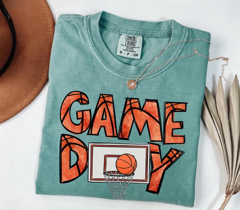 cute basketball shirt featuring a game day graphic made with basketball doodle font for a one of a kind piece