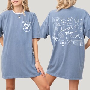 custom soccer t-shirt featuring a unique doodle graphic on the front and back. Customize the team name on the front and player number on the back to show your team pride. Crafted with the comfort colors 1717 tee
