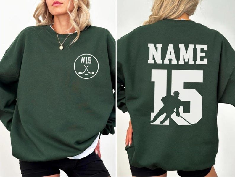 Custom hockey sweatshirt featuring a personalized hockey player name and number design on the back as well as jersey number on the front design.  Also, choose from a variety of hockey player silhouettes to further customize this hockey sweater