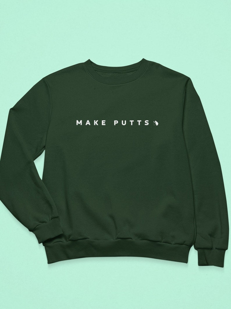 May include: A dark green sweatshirt with the text "MAKE PUTTS" in white on the front.