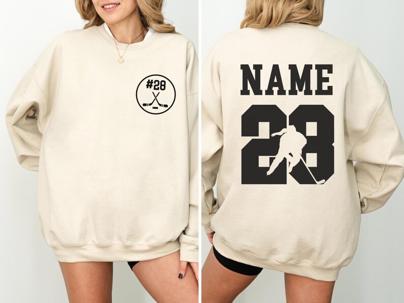 Custom hockey sweatshirt featuring a personalized hockey player name and number design on the back as well as jersey number on the front design.  Also, choose from a variety of hockey player silhouettes to further customize this hockey sweater