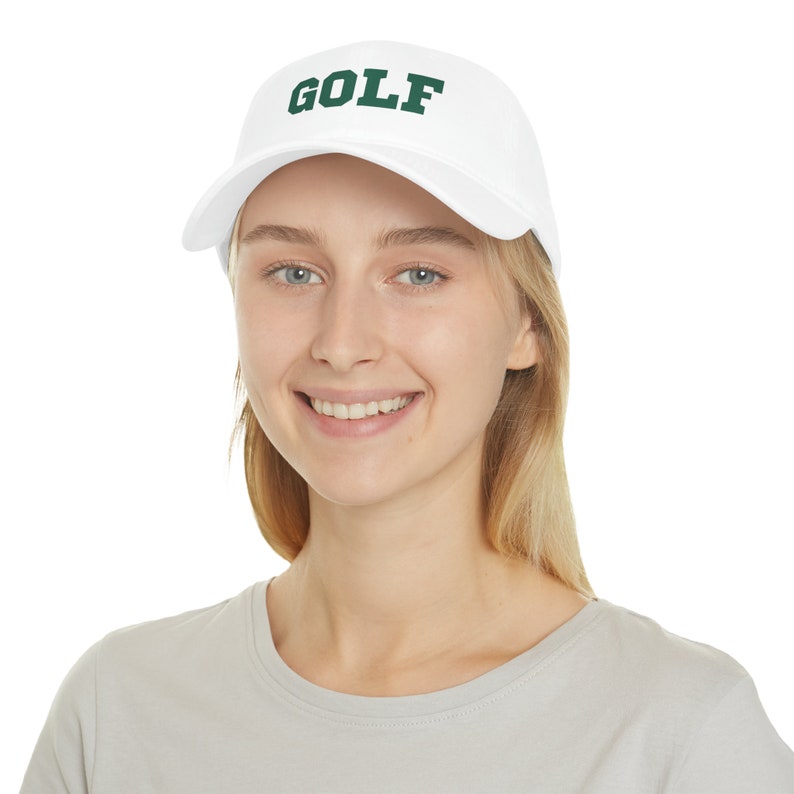 May include: A white baseball cap with a green embroidered "GOLF" logo.