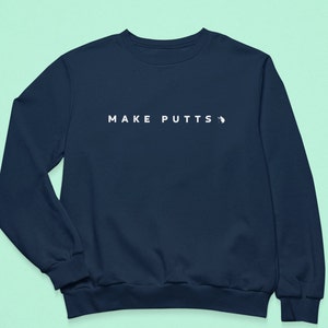 May include: A navy blue sweatshirt with the text "MAKE PUTTS" in white on the front.