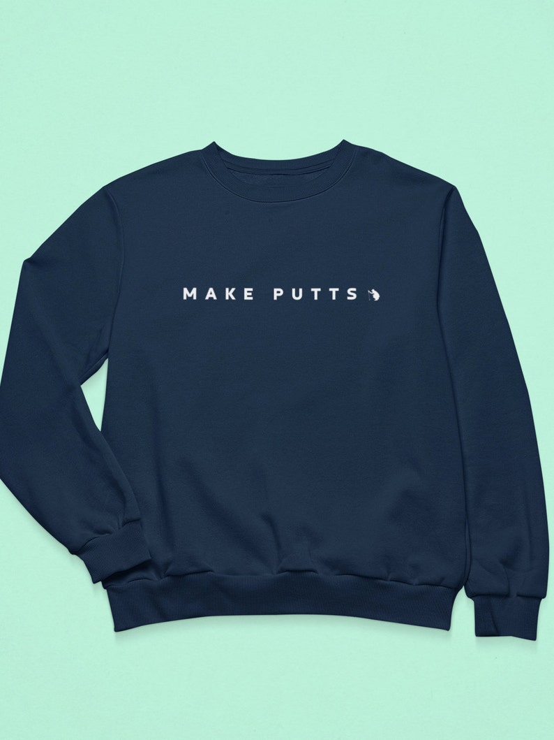 May include: A navy blue sweatshirt with the text "MAKE PUTTS" in white on the front.