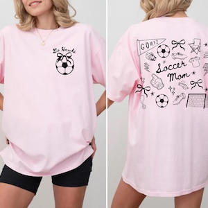 custom soccer t-shirt featuring a unique doodle graphic on the front and back. Customize the team name on the front and player number on the back to show your team pride. Crafted with the comfort colors 1717 tee