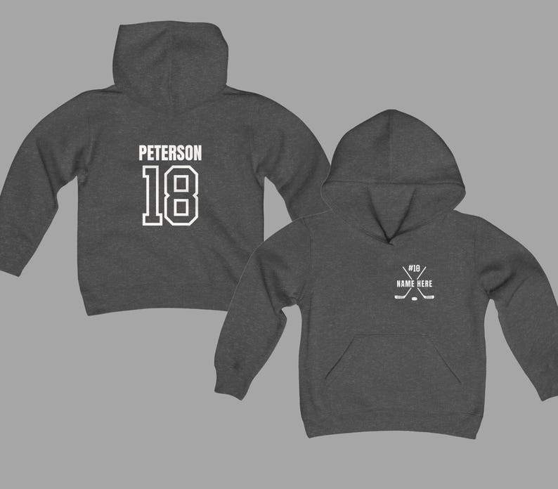 May include: Two charcoal gray hoodies. One displays "PETERSON" and the number "18" in white block letters. The other hoodie has a hockey stick graphic and the text "#18 NAME HERE" in white. Both hoodies have a front pocket and a hood.