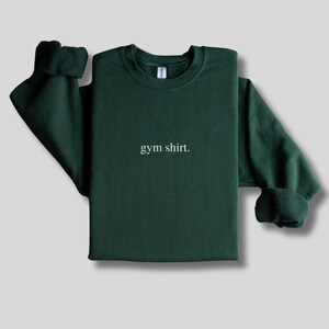 simple forest green gym sweatshirt featuring a minimalist text design. Made with the Gildan 18000 sweatshirt
