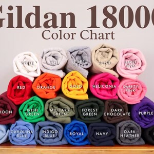 May include: A color chart of Gildan 18000 t-shirt colors. The chart shows 18 different colors, including white, ash, sport grey, sand, light pink, red, orange, gold, heliconia, safety pink, maroon, Irish green, military green, forest green, dark chocolate, purple, light blue, Carolina blue, indigo blue, royal blue, navy, dark heather, and black.