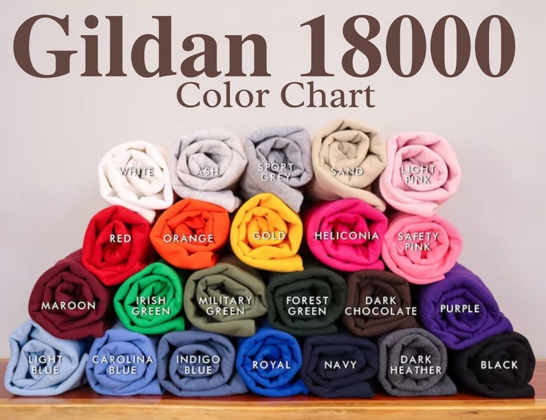 May include: A color chart of Gildan 18000 t-shirt colors. The chart shows 18 different colors, including white, ash, sport grey, sand, light pink, red, orange, gold, heliconia, safety pink, maroon, Irish green, military green, forest green, dark chocolate, purple, light blue, Carolina blue, indigo blue, royal blue, navy, dark heather, and black.