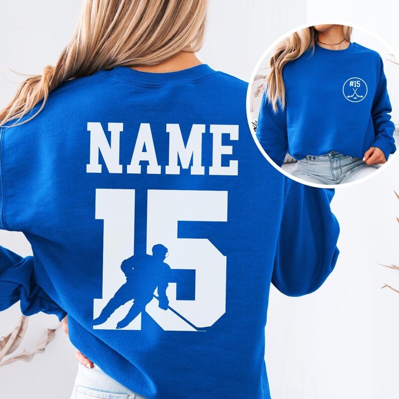 Custom hockey sweatshirt featuring a personalized hockey player name and number design on the back as well as jersey number on the front design.  Also, choose from a variety of hockey player silhouettes to further customize this hockey sweater