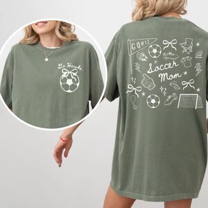 custom soccer t-shirt featuring a unique doodle graphic on the front and back. Customize the team name on the front and player number on the back to show your team pride. Crafted with the comfort colors 1717 tee