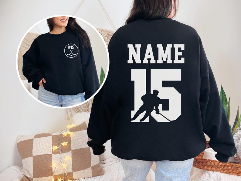 Custom hockey sweatshirt featuring a personalized hockey player name and number design on the back as well as jersey number on the front design.  Also, choose from a variety of hockey player silhouettes to further customize this hockey sweater