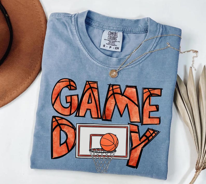 cute basketball shirt featuring a game day graphic made with basketball doodle font for a one of a kind piece