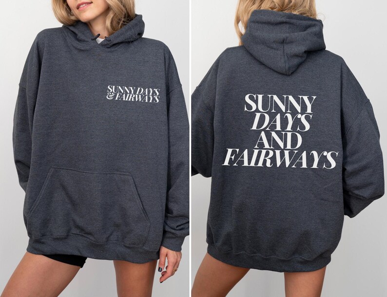 dark heather golf themed hoodie with sunny days and fairways in a bold, trendy font on the back of the shirt. On the front, is a small sunny days and fairways graphic on the left chest