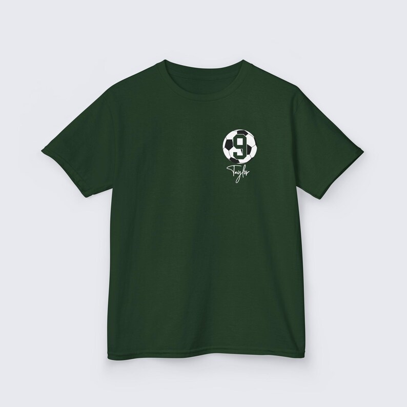 May include: A dark green t-shirt with a white soccer ball graphic and the number 9. The text "Taylor" is written in white below the ball.