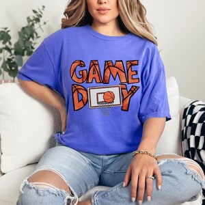 cute basketball shirt featuring a game day graphic made with basketball doodle font for a one of a kind piece
