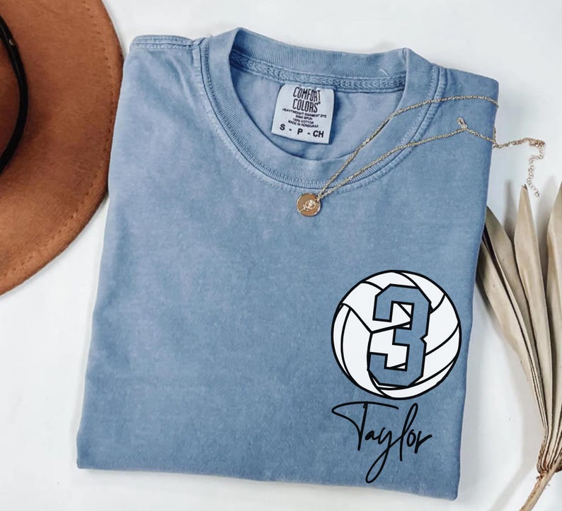 Blue jean Comfort Colors 1717 t-shirt with a customizable name and number volleyball graphic.