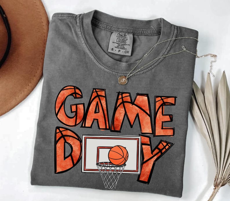 cute basketball shirt featuring a game day graphic made with basketball doodle font for a one of a kind piece