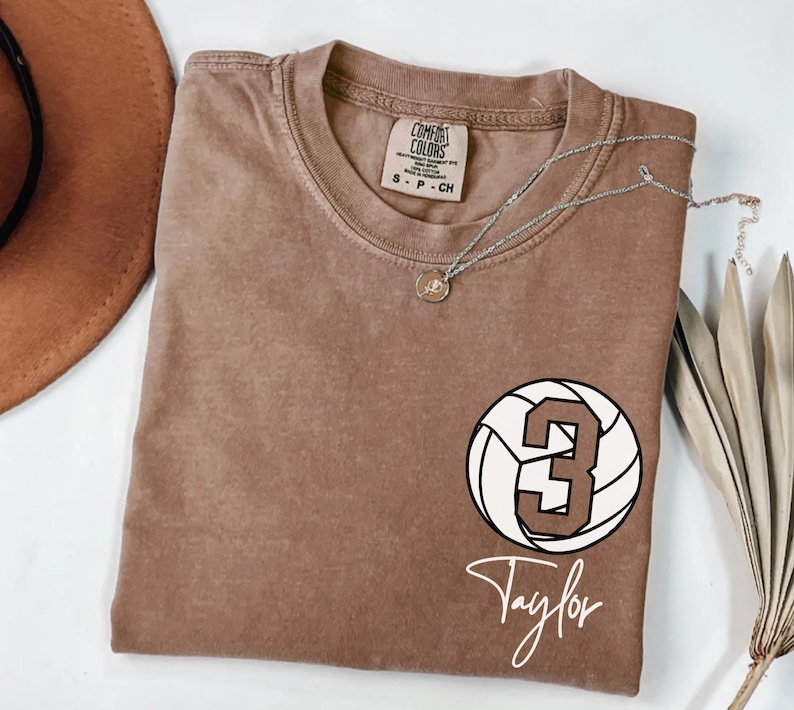 Espresso Comfort Colors 1717 t-shirt with a customizable name and number volleyball graphic.