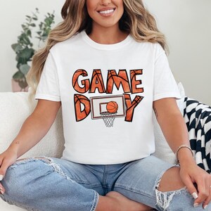 cute basketball shirt featuring a game day graphic made with basketball doodle font for a one of a kind piece