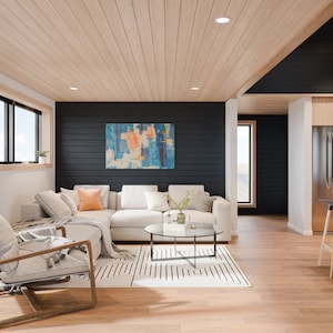 Puede incluir: Un sal&oacute;n moderno con un sof&aacute; seccional de color claro, una mesa de centro redonda de cristal y una alfombra estampada. La habitaci&oacute;n cuenta con una pared de acento negra con una pintura abstracta, pisos de madera y un techo de madera clara. Se ve un refrigerador de acero inoxidable.