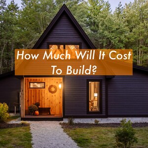 May include: A dark gray modern house with a gabled roof, surrounded by trees. The entrance features wooden paneling and a small wreath. Text on the image reads: "How Much Will It Cost To Build?"
