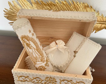 wooden box adorned with the Virgen Maria holds an equally exquisite baptism candle set.
