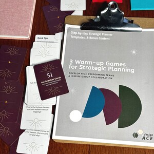 May include: A gray and white clipboard with the text "3 Warm-up Games for Strategic Planning" and "Develop High Performing Teams & Inspire Group Collaboration". The clipboard is on a wooden table with a stack of red, white, and gold cards with the text "Ice-breaker Cards" and "51".