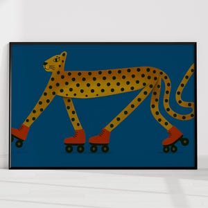 May include: A framed art print depicting a cheetah with yellow spots and orange roller skates on a dark blue background. The cheetah has a yellow body with black spots. The roller skates are orange with black wheels.