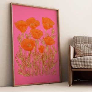 May include: A framed print of orange poppy flowers on a pink background. The flowers are outlined in gold and have a vintage style.