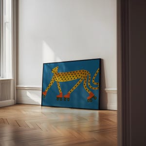 May include: A framed art print showing a yellow cheetah with black spots, wearing orange roller skates, against a teal background. The cheetah is illustrated in a cartoon style, giving the artwork a playful and whimsical feel.