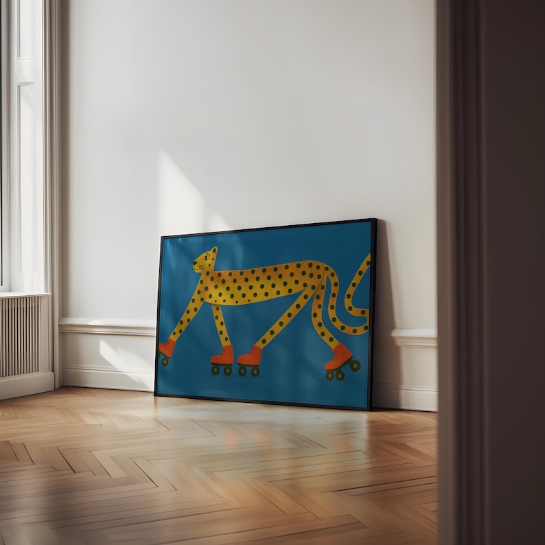 May include: A framed art print showing a yellow cheetah with black spots, wearing orange roller skates, against a teal background. The cheetah is illustrated in a cartoon style, giving the artwork a playful and whimsical feel.