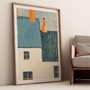 Op de afbeelding: Een ingelijst abstract schilderij van een huis met een blauw dak, een oranje schoorsteen en groene accenten. Het huis is geschilderd in een minimalistische stijl met eenvoudige lijnen en vormen.