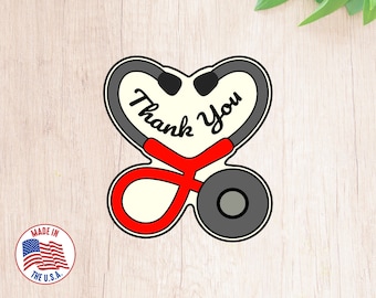May include: Red and gray stethoscope shaped like a heart with the words "Thank You" inside.